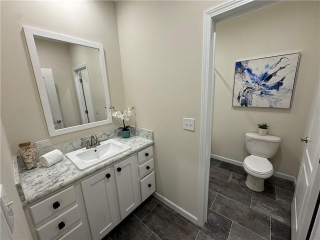 bathroom with toilet and vanity