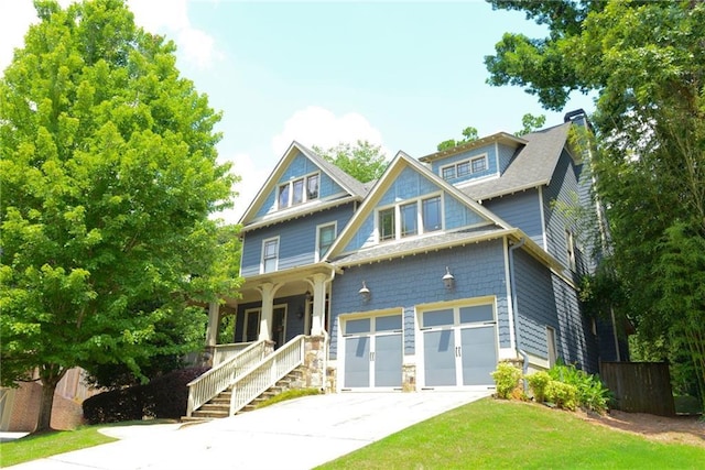 craftsman inspired home with covered porch and a garage