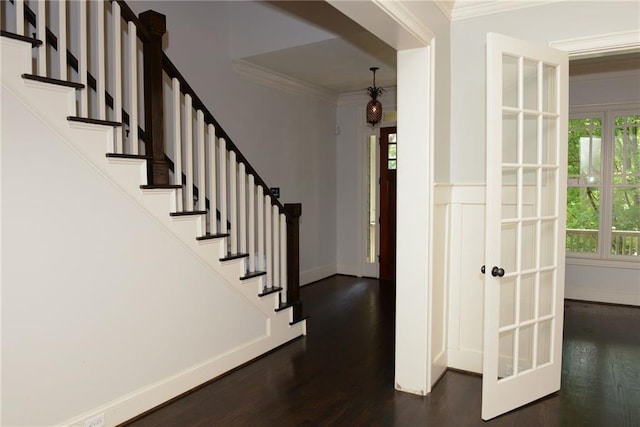 foyer entrance featuring french doors, dark hardwood / wood-style flooring, and ornamental molding