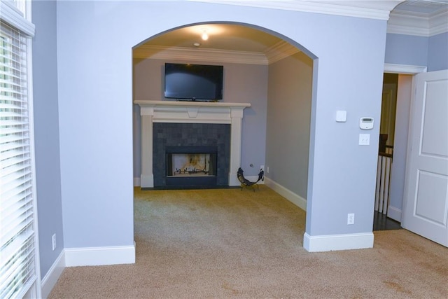 unfurnished living room with crown molding and light carpet