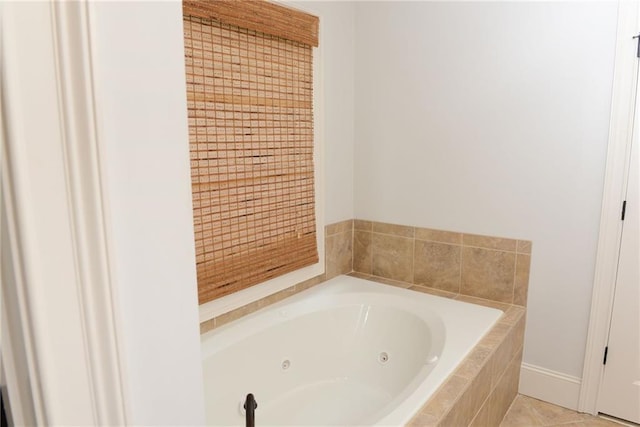 bathroom featuring a relaxing tiled bath and tile floors