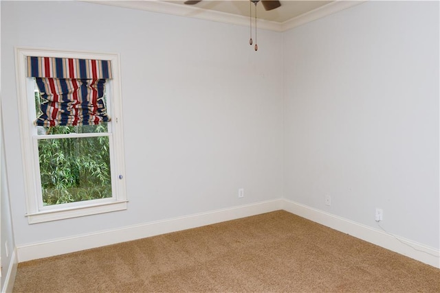 spare room featuring light colored carpet and ceiling fan