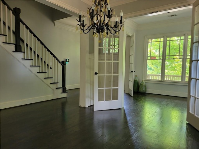 interior space featuring a notable chandelier, dark wood-type flooring, french doors, and crown molding