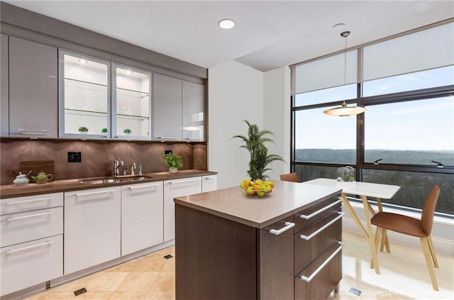 750 Park Ave NE Unit 19E, Atlanta, GA 30326 - kitchen featuring a kitchen island, recessed lighting, a sink, white cabinets, and backsplash