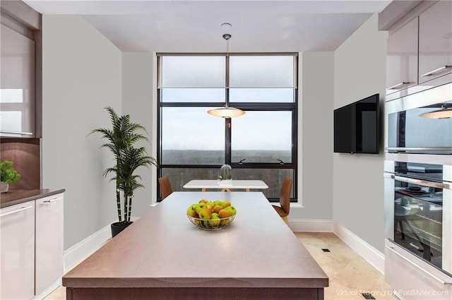 750 Park Ave NE Unit 19E, Atlanta, GA 30326 - dining room with baseboards and expansive windows