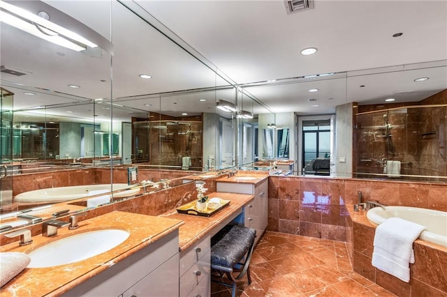 750 Park Ave NE Unit 19E, Atlanta, GA 30326 - bathroom with a sink, visible vents, a stall shower, and a bath