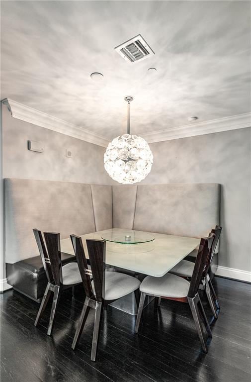 750 Park Ave NE Unit 19E, Atlanta, GA 30326 - dining space with visible vents, baseboards, ornamental molding, and dark wood-style flooring