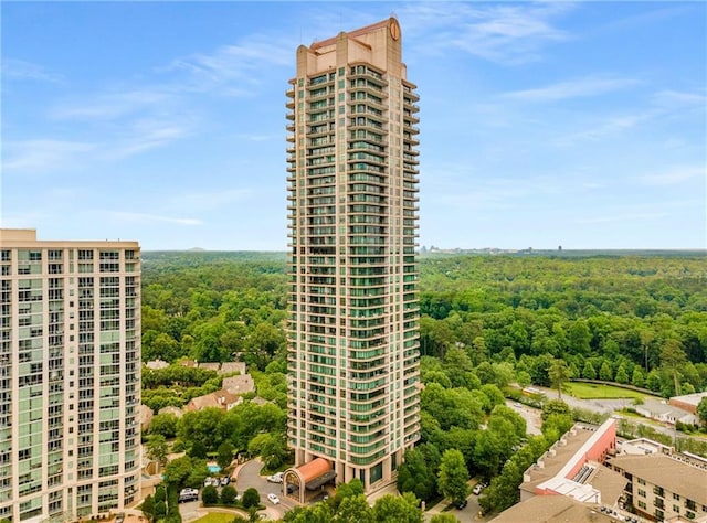 750 Park Ave NE Unit 19E, Atlanta, GA 30326 - view of building exterior with a forest view