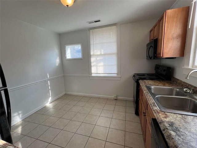 35 Elmwood St, Rome, GA 30161 - kitchen with visible vents, a sink, a wealth of natural light, brown cabinetry, and black appliances