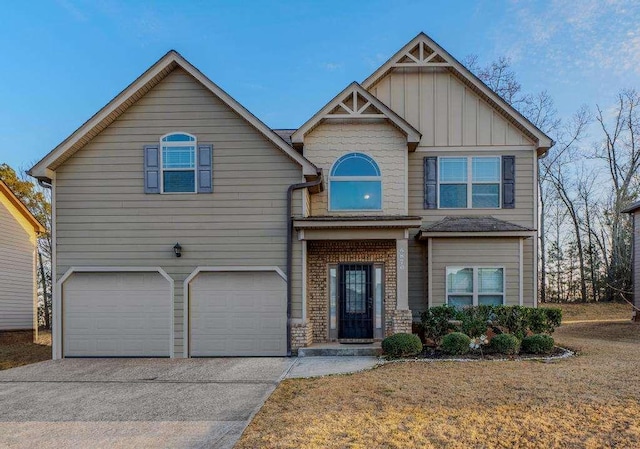 craftsman-style house with board and batten siding, concrete driveway, brick siding, and a garage