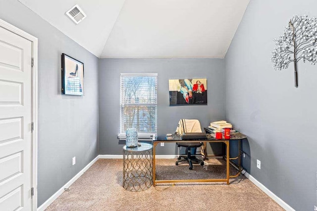 carpeted office featuring lofted ceiling, baseboards, and visible vents