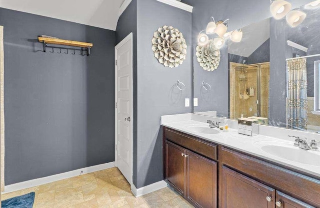 bathroom with a stall shower, a sink, lofted ceiling, and double vanity