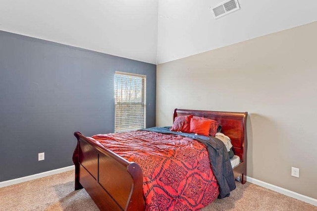 bedroom featuring lofted ceiling, carpet, visible vents, and baseboards