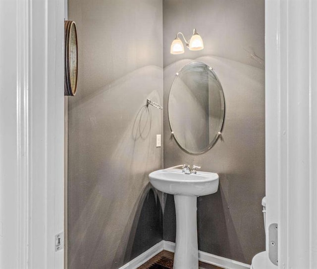 half bathroom with baseboards