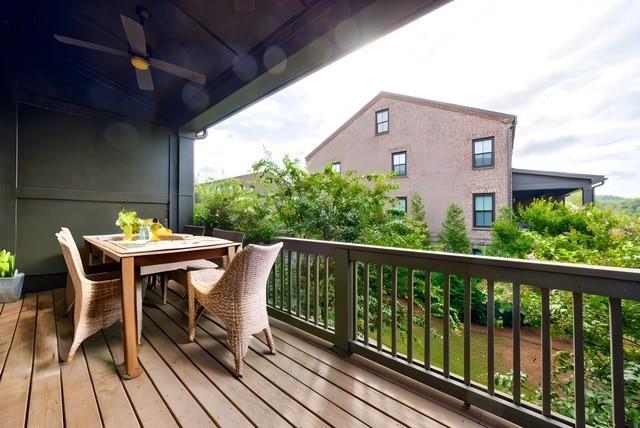 balcony with outdoor dining space and ceiling fan