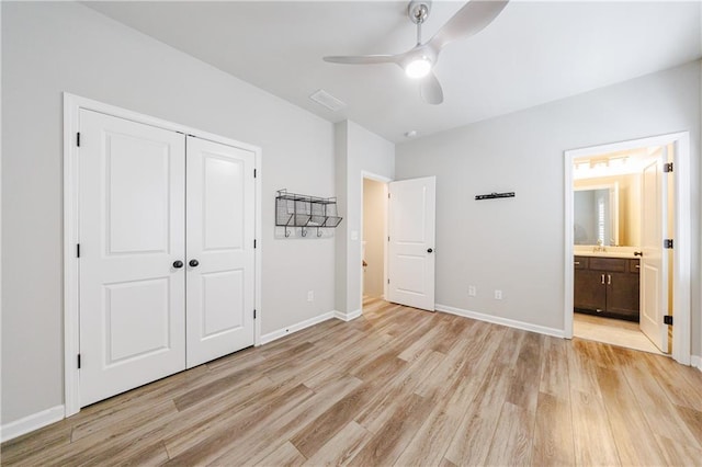 unfurnished bedroom with visible vents, light wood-type flooring, baseboards, a closet, and connected bathroom