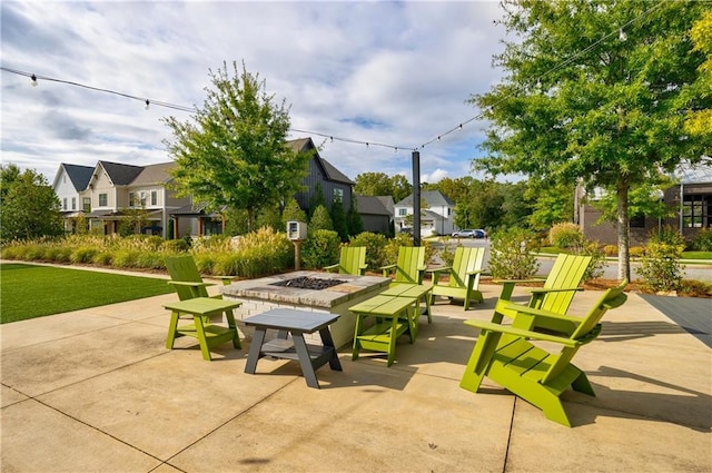 view of property's community featuring a patio, a fire pit, and a residential view
