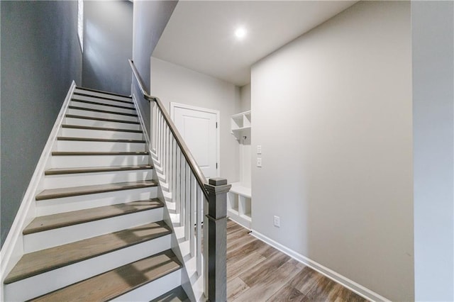 stairway featuring baseboards, recessed lighting, and wood finished floors