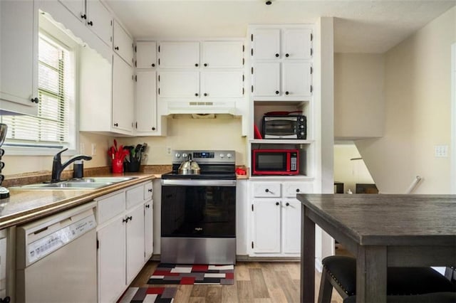 kitchen with white dishwasher, under cabinet range hood, a sink, white cabinets, and stainless steel electric stove