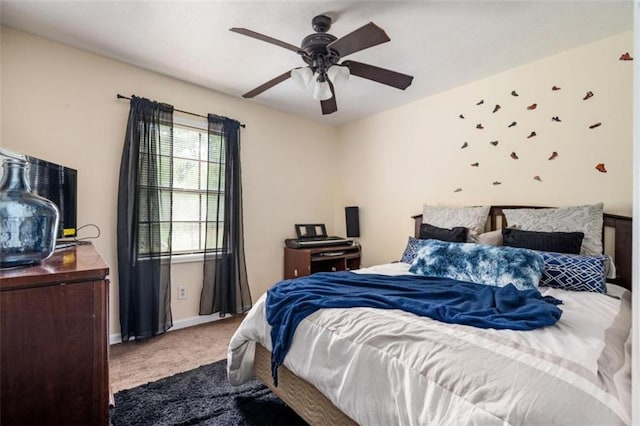 carpeted bedroom featuring ceiling fan and baseboards