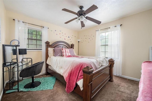carpeted bedroom with multiple windows, baseboards, and a ceiling fan
