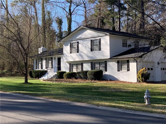 split level home with a front yard