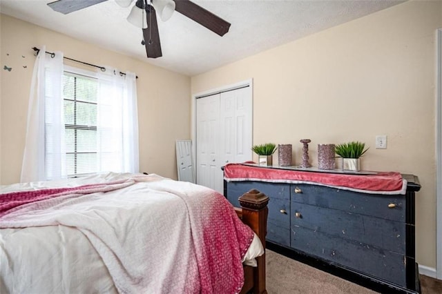 carpeted bedroom with a closet and a ceiling fan