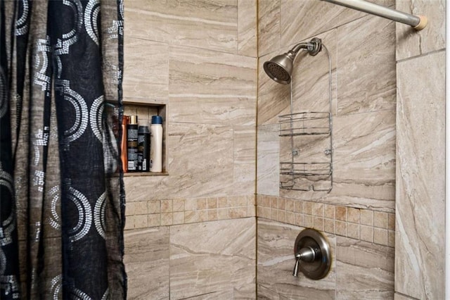 full bath with a tile shower