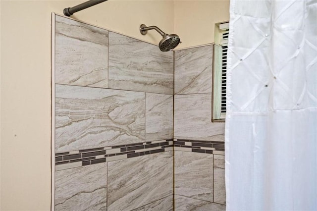 bathroom with a tile shower