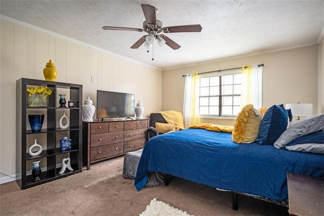 bedroom with ornamental molding, a textured ceiling, carpet flooring, and a ceiling fan