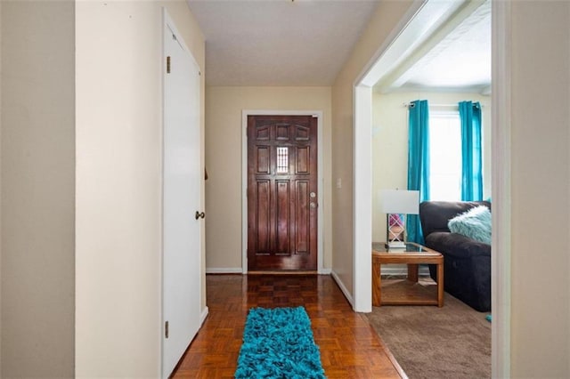 foyer featuring baseboards