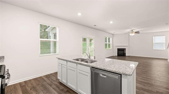 kitchen with white cabinetry, sink, ceiling fan, stainless steel appliances, and a center island with sink