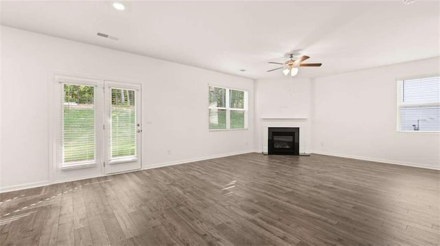 unfurnished living room featuring ceiling fan and dark wood-type flooring