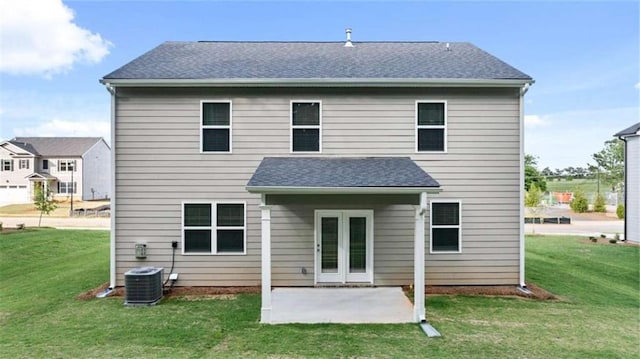 rear view of property featuring a patio, central AC, and a lawn