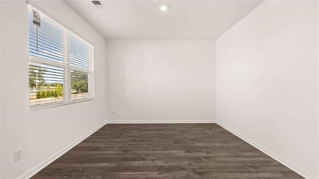 unfurnished room featuring dark hardwood / wood-style floors