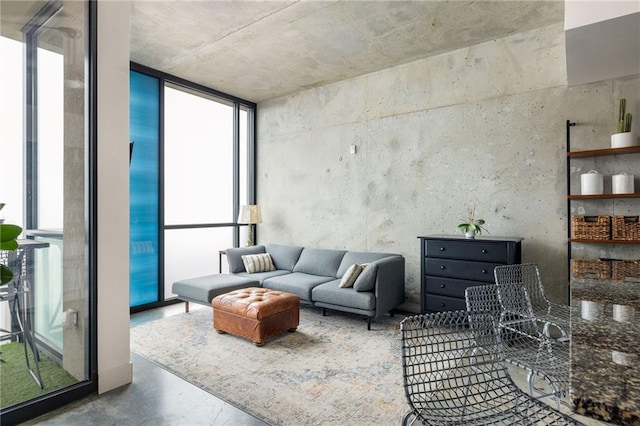 living room with floor to ceiling windows, concrete floors, and a wealth of natural light