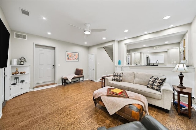 living room featuring visible vents, wood finished floors, and recessed lighting