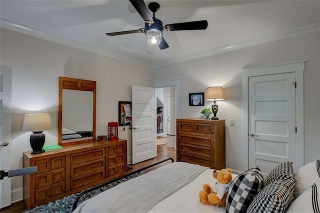 bedroom featuring hardwood / wood-style flooring, ceiling fan, and ornamental molding