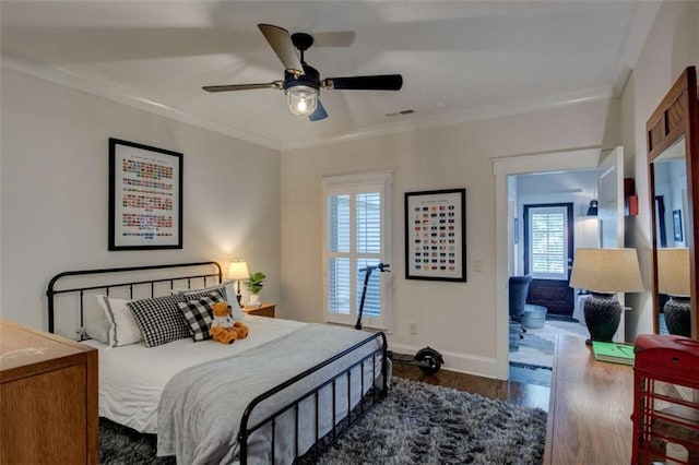 bedroom with ceiling fan, dark hardwood / wood-style flooring, and crown molding