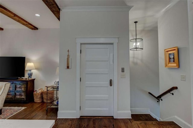 entryway featuring dark hardwood / wood-style floors, beam ceiling, and an inviting chandelier