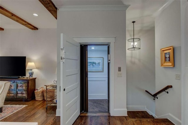 entrance foyer with beam ceiling, dark hardwood / wood-style flooring, and a notable chandelier