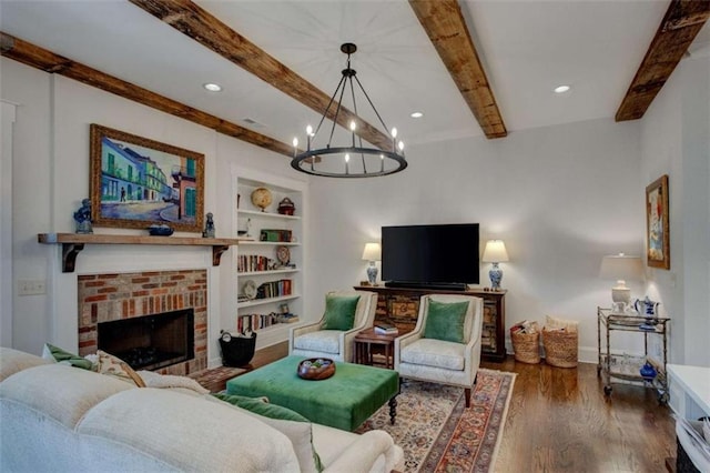 living room featuring an inviting chandelier, dark hardwood / wood-style floors, built in features, a fireplace, and beam ceiling