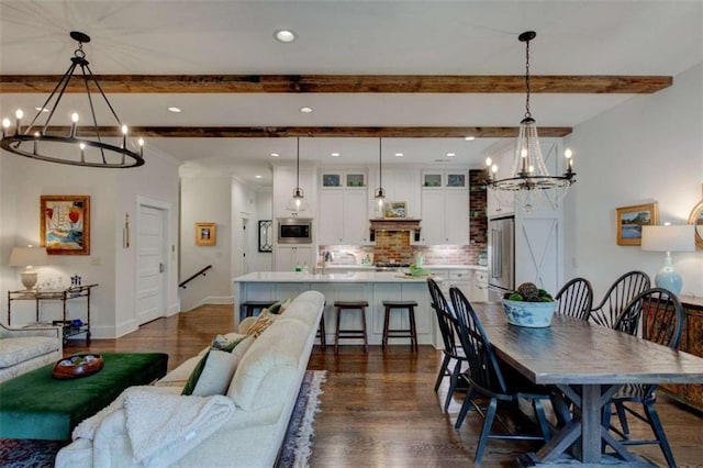 dining area with beamed ceiling, dark wood-type flooring, and a chandelier