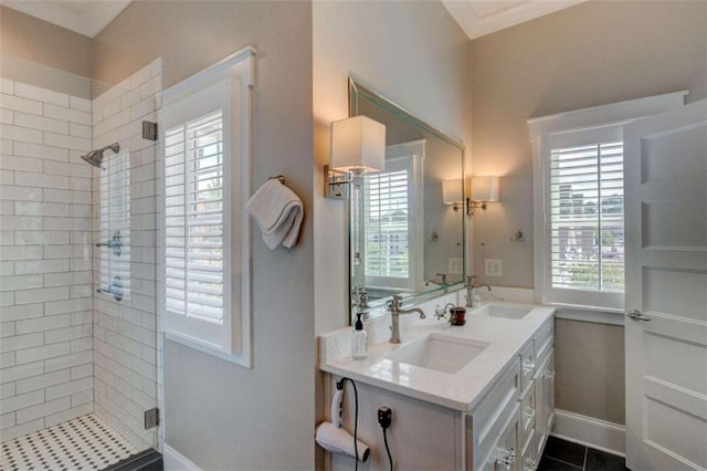 bathroom featuring tile patterned flooring, vanity, a healthy amount of sunlight, and an enclosed shower