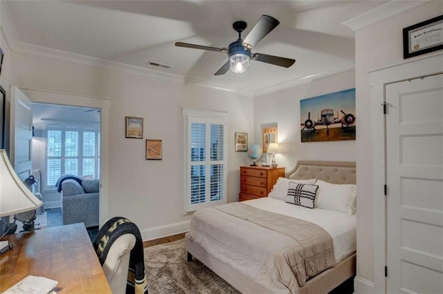 bedroom with ceiling fan, hardwood / wood-style floors, and ornamental molding