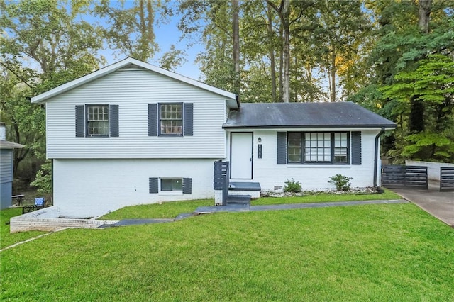 split level home with a front lawn and brick siding