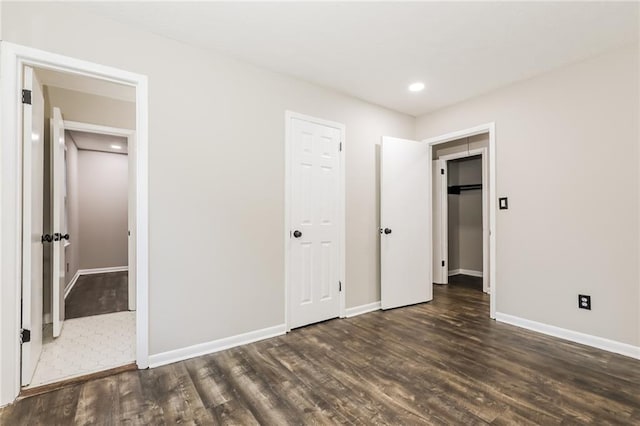 unfurnished bedroom featuring wood finished floors, baseboards, and recessed lighting