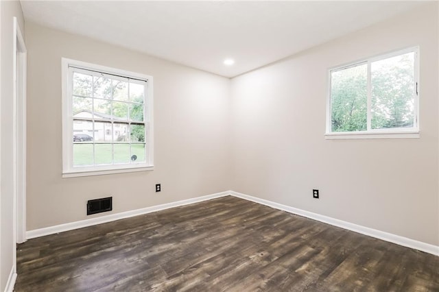 unfurnished room featuring baseboards, dark wood finished floors, and recessed lighting