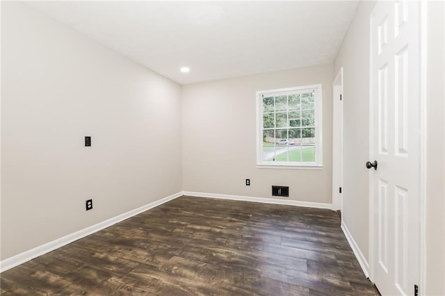 spare room with baseboards, dark wood-style flooring, and recessed lighting