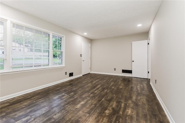 unfurnished room with wood finished floors, baseboards, and recessed lighting